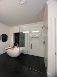 a black and white bathroom with a glass shower