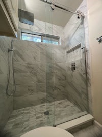 a bathroom with a glass shower door